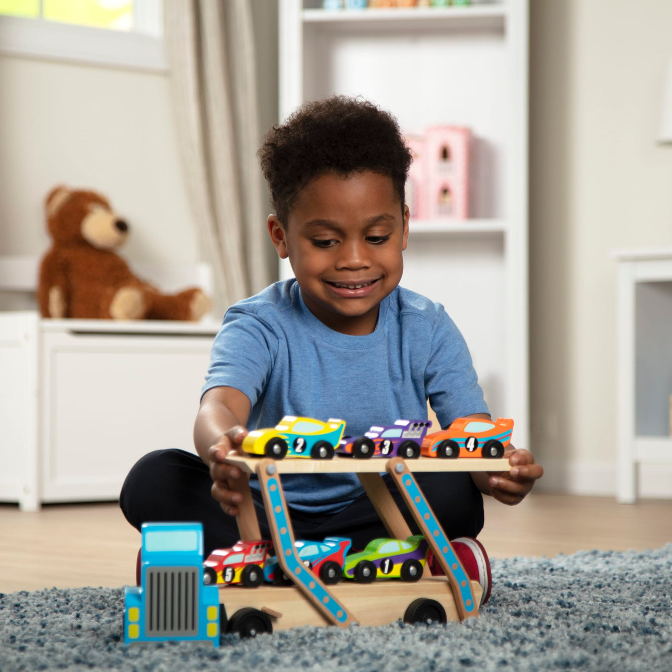 Boy playing with wooden car set
