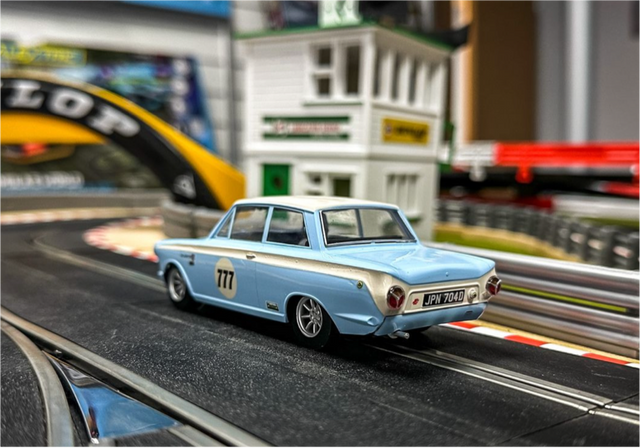 Baby blue old fashioned European car with racing number 777 on the door