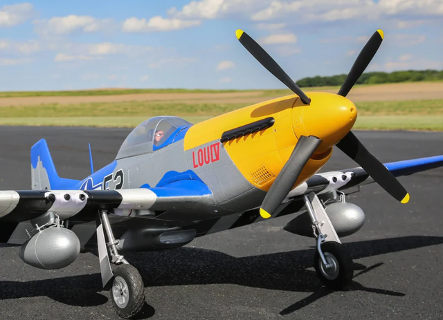 Remote control airplane with propeller on runway in airfield